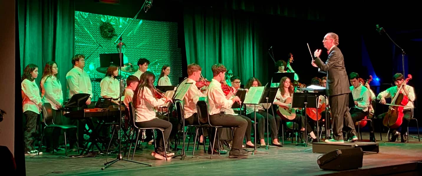 Music students on stage playing instruments