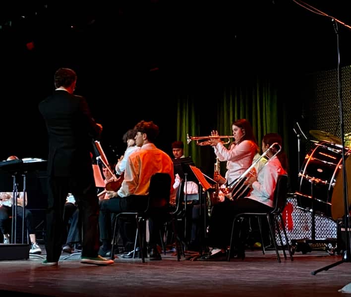 Music students on stage playing instruments