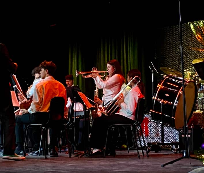 Music students on stage playing instruments