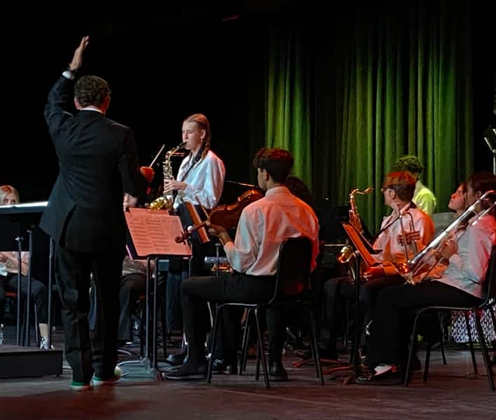 Music students on stage playing instruments