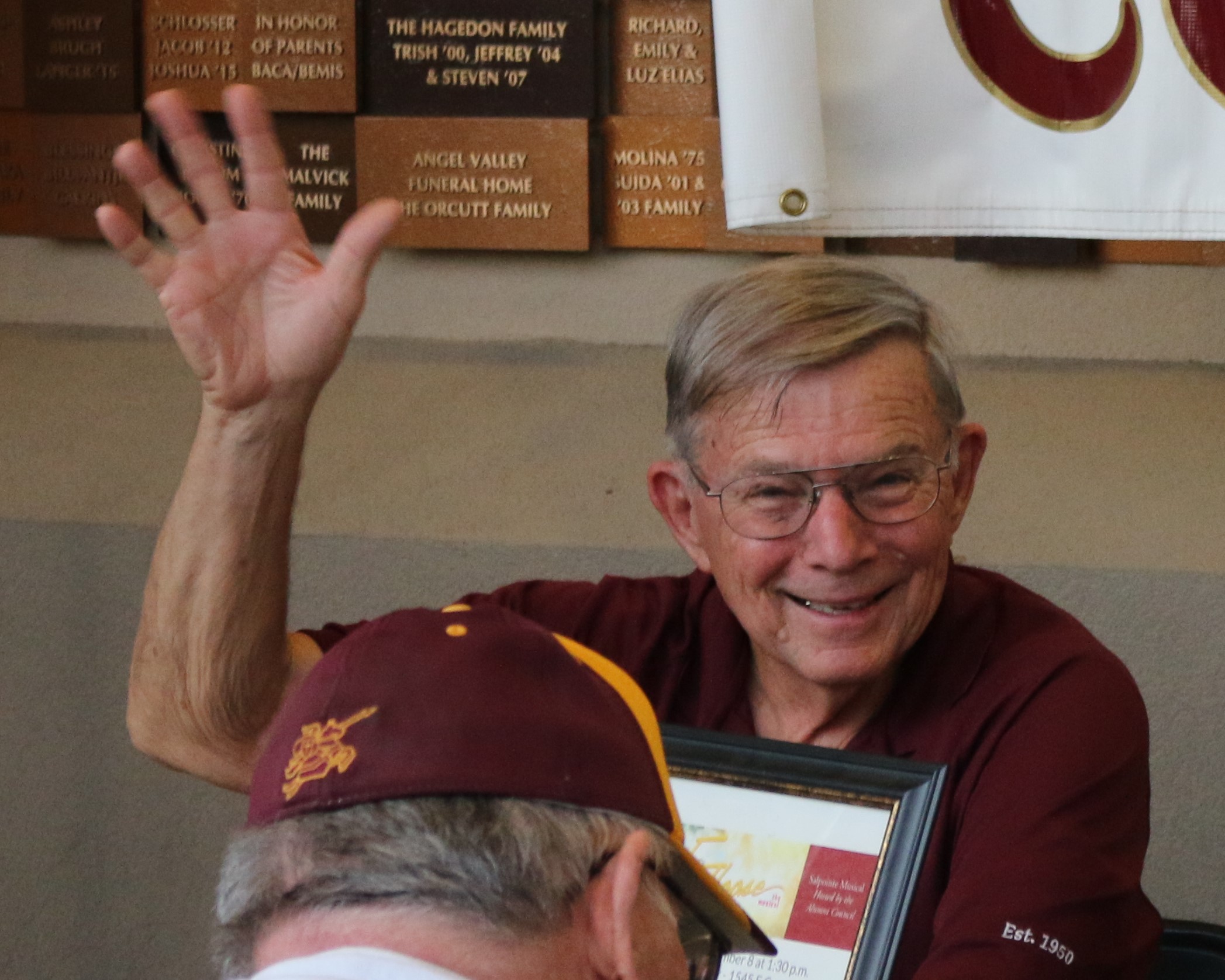 Older man raising hand