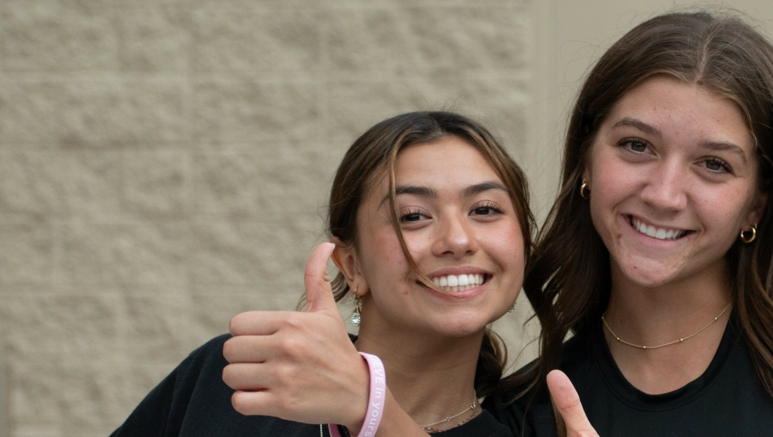 Students giving thumbs up