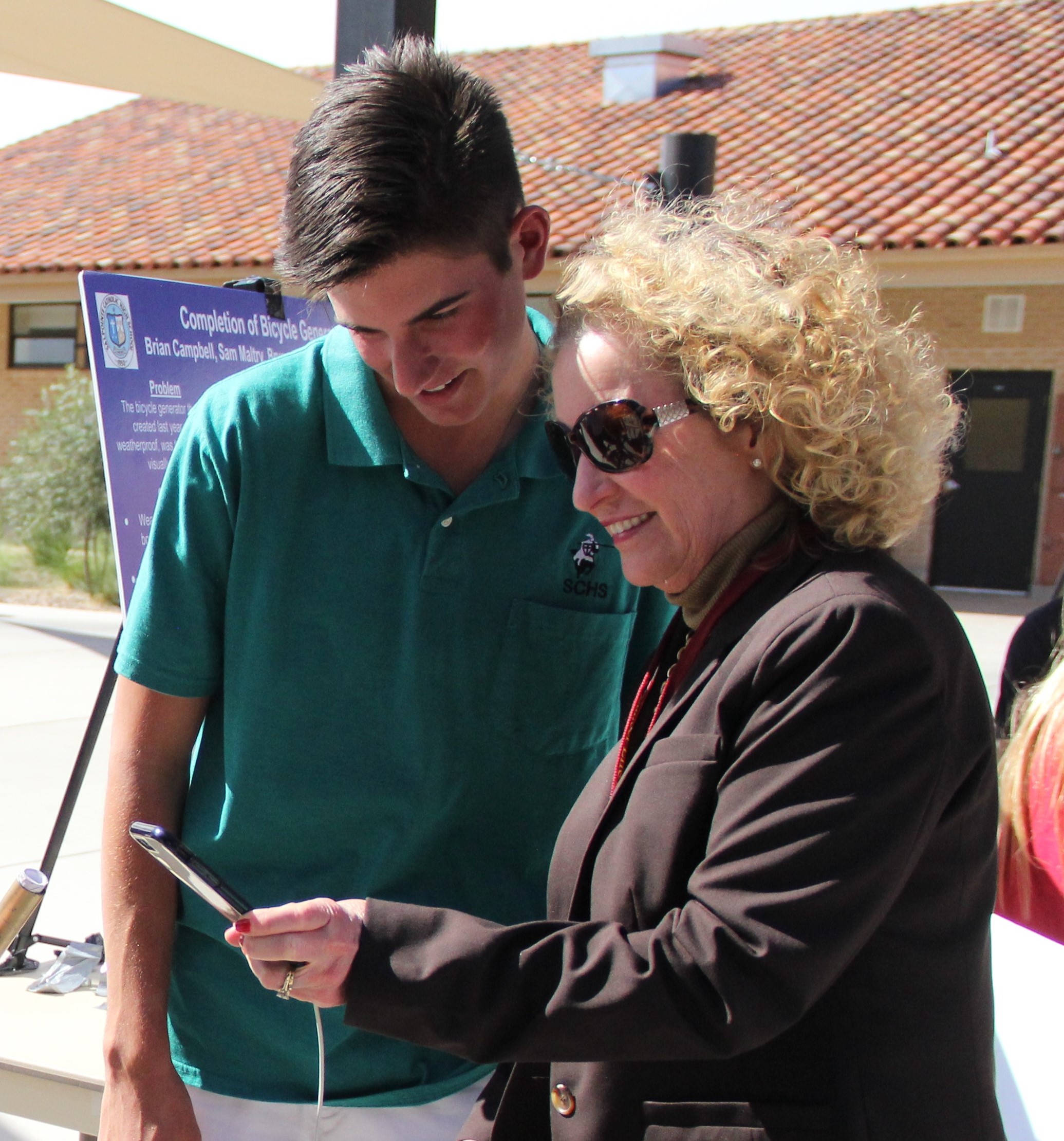 Student and older women looking at phone