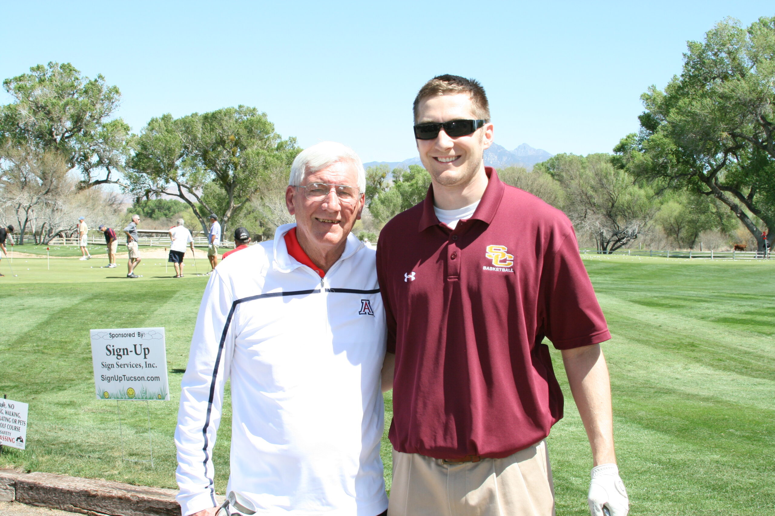 Student and older man on the golf course