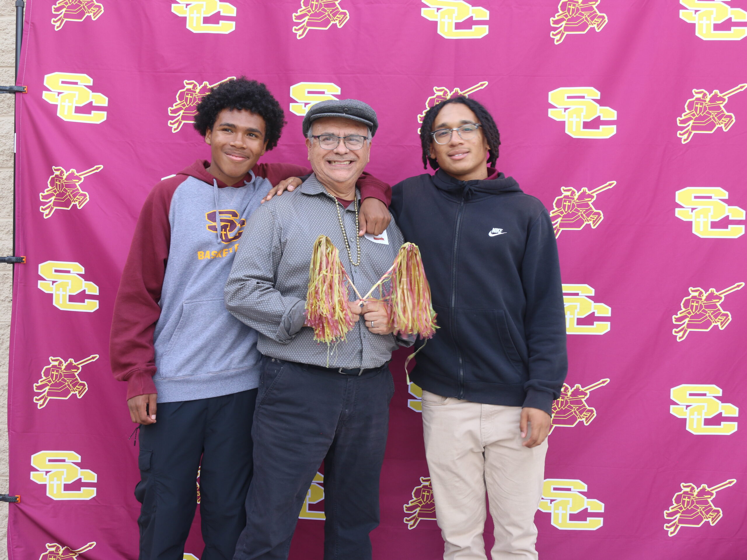 Students posing with older man