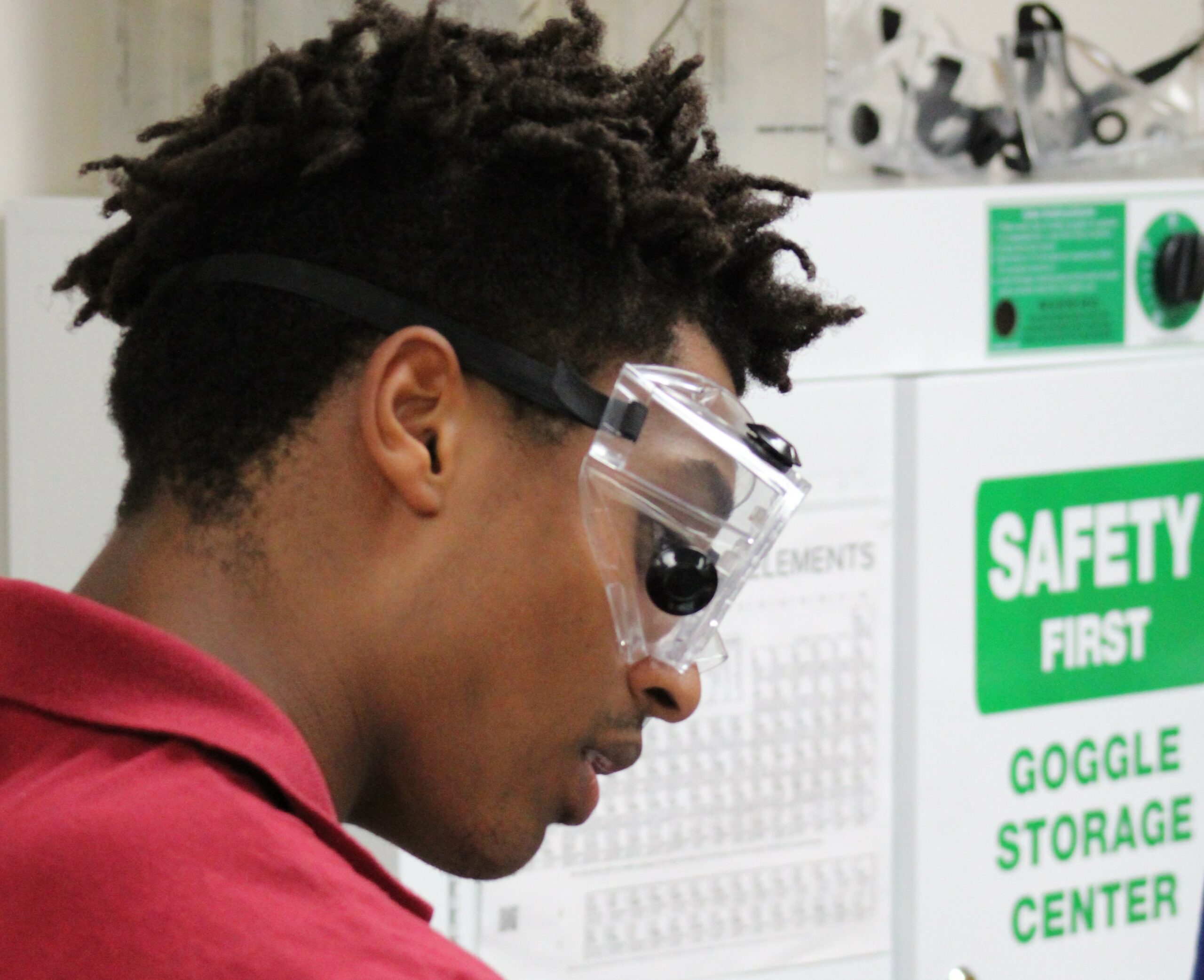 Student in classroom with safety glasses