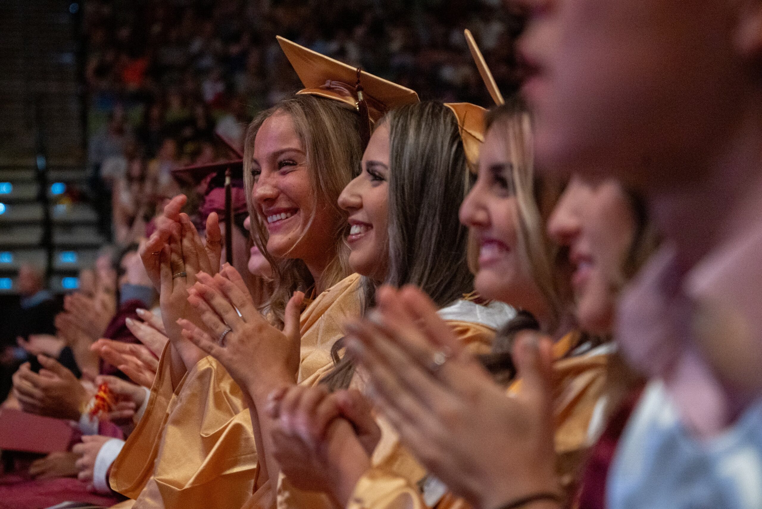 Female at graduation clapping