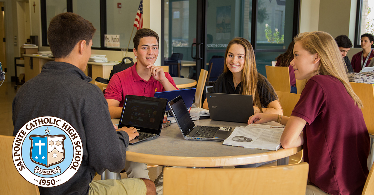 Students at a table with laptops